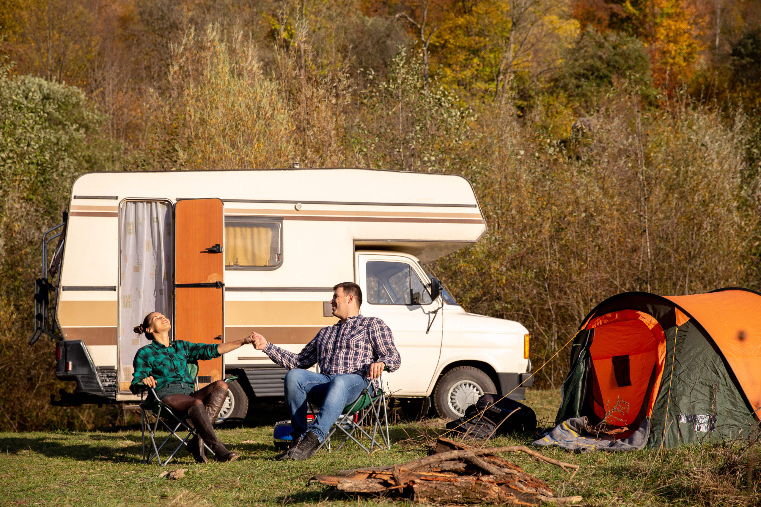 couple in love sitting on camping chairs and enjoying the beautiful weather